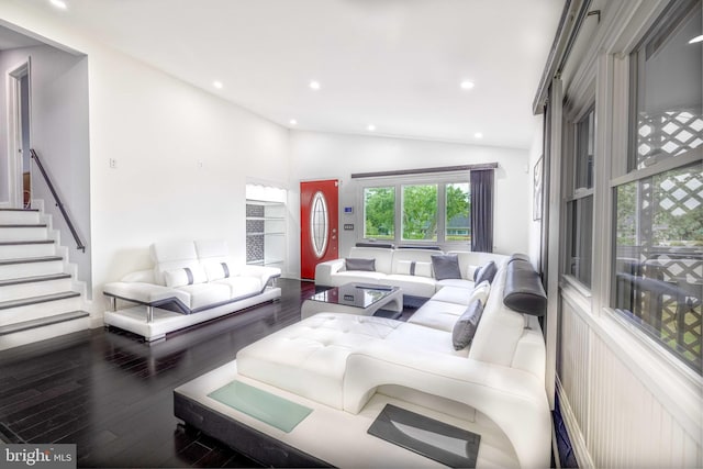 living room with lofted ceiling and hardwood / wood-style flooring