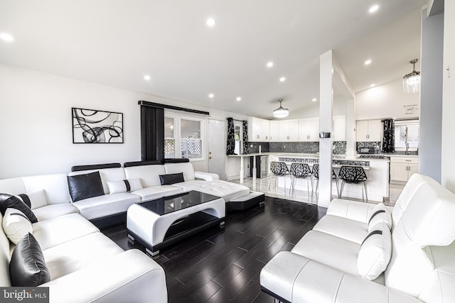 living room featuring lofted ceiling