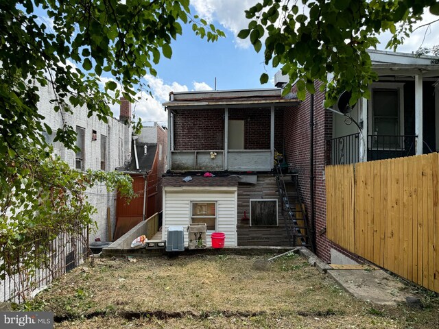 1717 W 4th St, Wilmington, DE 19805 - rear view of property featuring fence, stairway, and brick siding