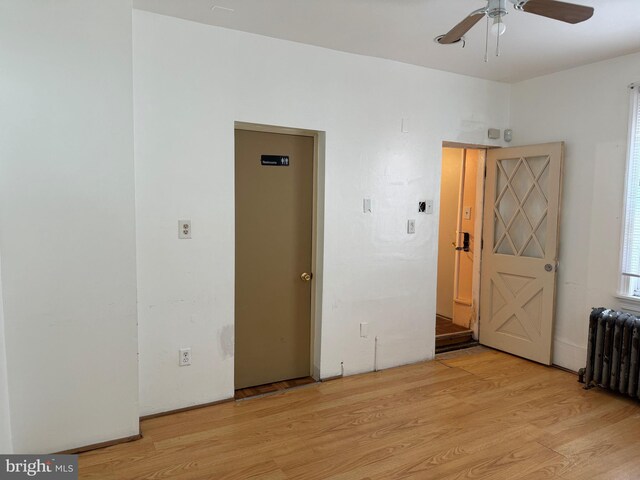 1717 W 4th St, Wilmington, DE 19805 - spare room featuring light wood-type flooring, radiator heating unit, and a ceiling fan