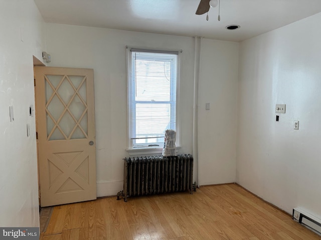 1717 W 4th St, Wilmington, DE 19805 - spare room featuring radiator heating unit, baseboard heating, ceiling fan, and light wood-type flooring