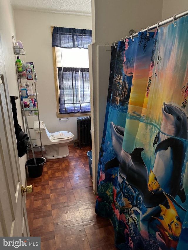 1717 W 4th St, Wilmington, DE 19805 - full bath with radiator, toilet, a textured ceiling, curtained shower, and tile patterned floors
