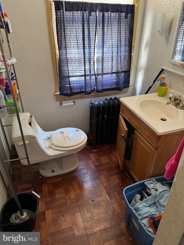 1717 W 4th St, Wilmington, DE 19805 - bathroom featuring radiator, toilet, and vanity