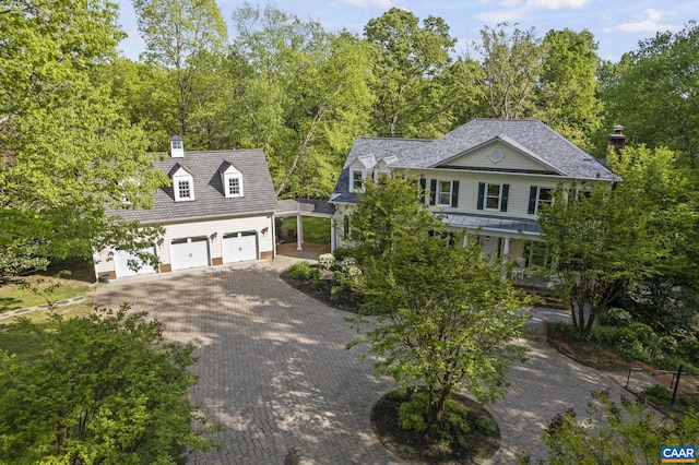 view of front of house with a porch, a garage, and an outdoor structure