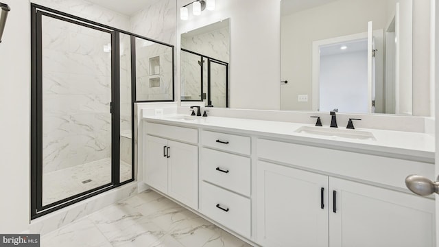 bathroom with a shower with door and vanity