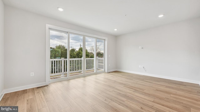 spare room with light wood-type flooring