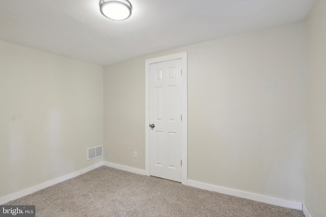 spare room with light colored carpet