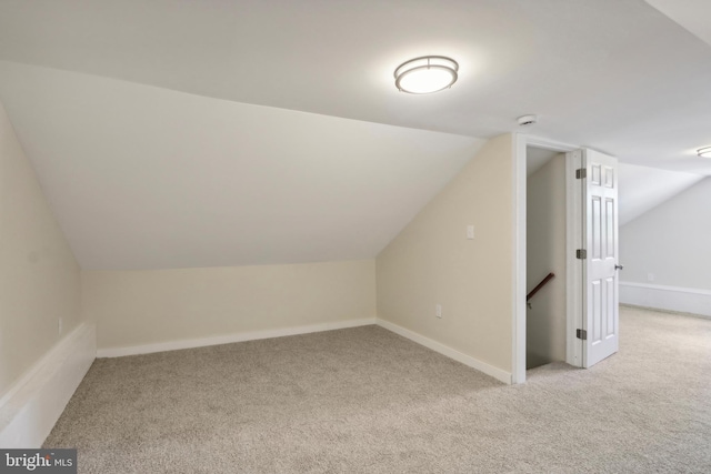 bonus room featuring light carpet and lofted ceiling