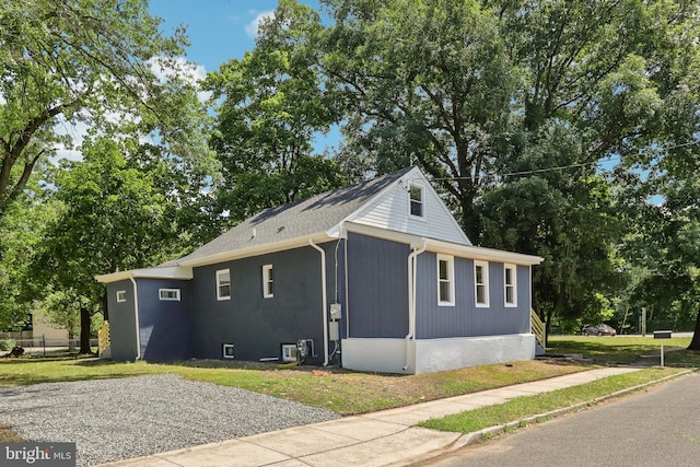 view of side of home with a lawn