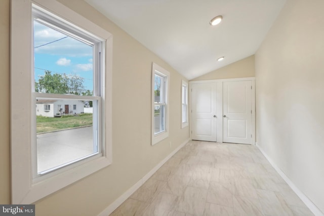 hall featuring vaulted ceiling