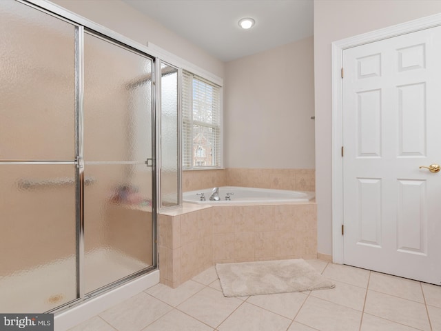 bathroom featuring tile patterned floors and independent shower and bath