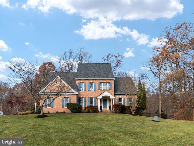 colonial home with a front lawn