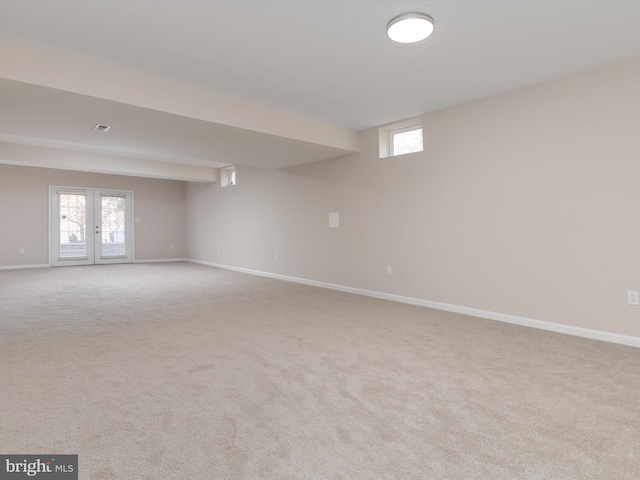 basement with light carpet and french doors