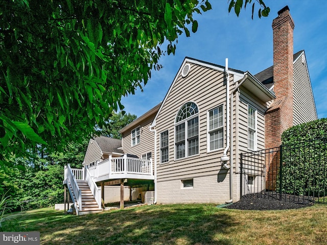 back of house featuring a yard and a deck