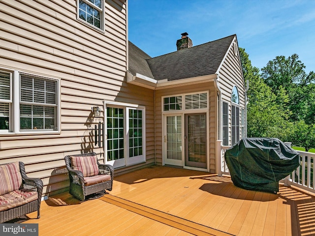 wooden terrace featuring a grill