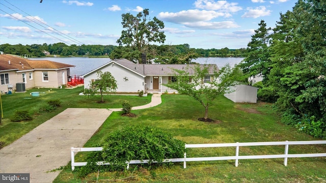 view of front of house with cooling unit, a water view, and a front yard