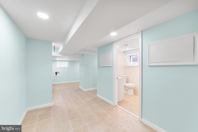 hall featuring light tile patterned flooring and a wealth of natural light