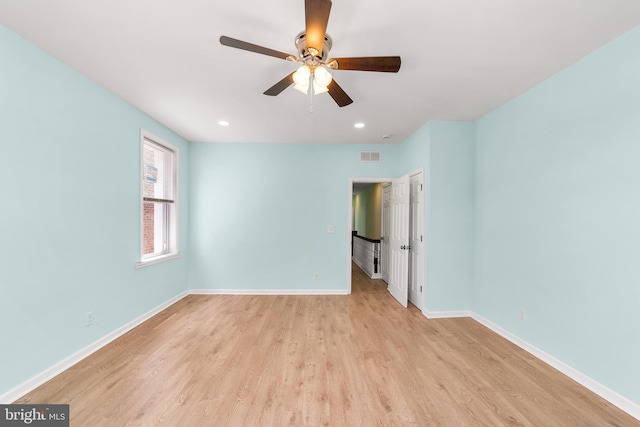 empty room featuring ceiling fan and light wood-type flooring