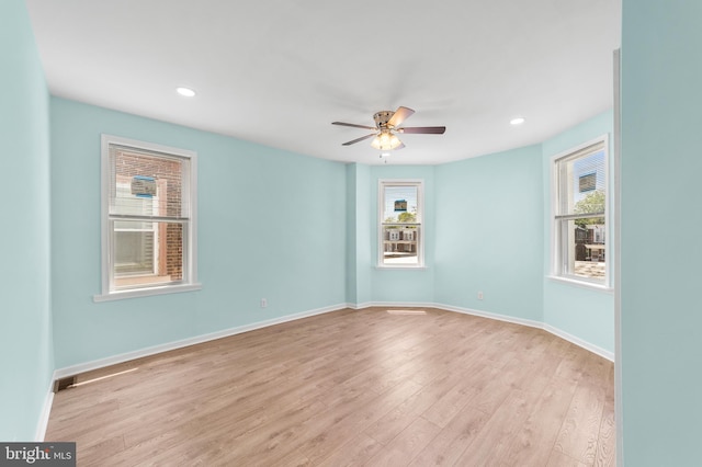 unfurnished room with ceiling fan, a healthy amount of sunlight, and light hardwood / wood-style flooring