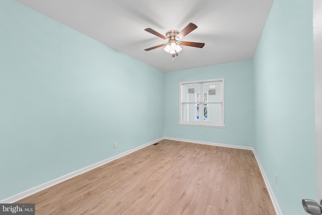 spare room with ceiling fan and light wood-type flooring