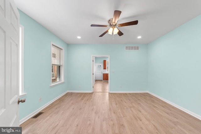 spare room featuring light hardwood / wood-style flooring and ceiling fan