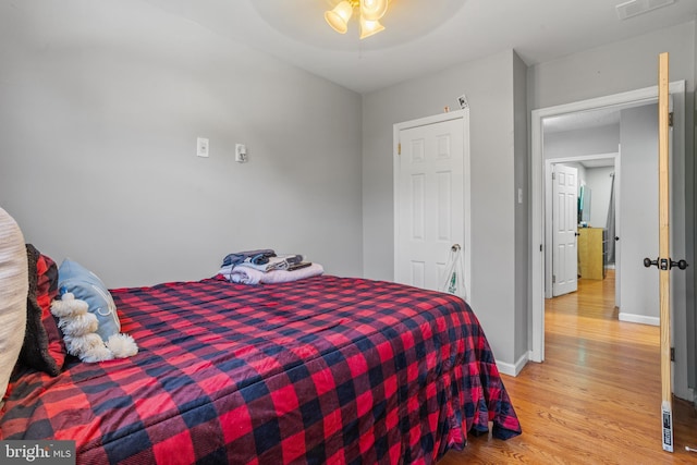 bedroom with light wood-type flooring and ceiling fan