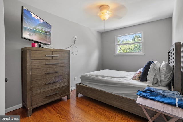 bedroom with ceiling fan and wood-type flooring