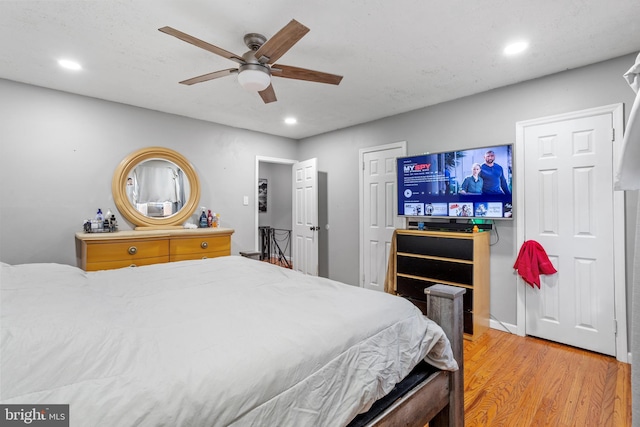 bedroom with ceiling fan and wood-type flooring