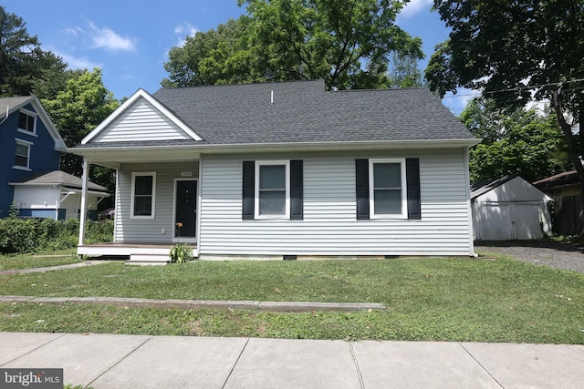 view of front of home featuring a front yard and a porch