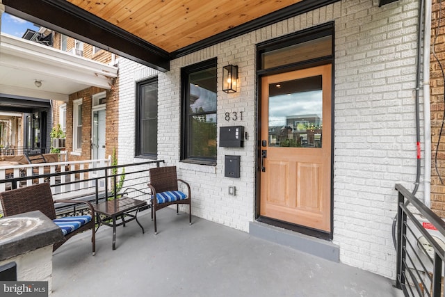 doorway to property featuring covered porch