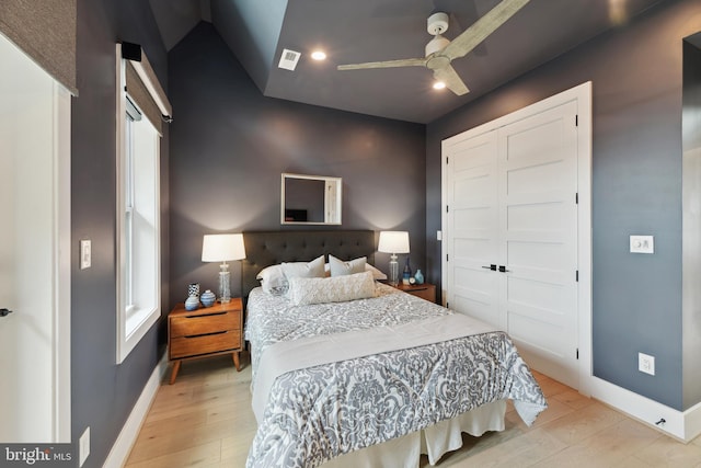 bedroom featuring ceiling fan, a closet, and light wood-type flooring