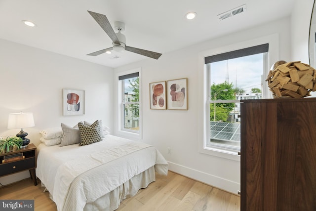 bedroom with light wood-type flooring and ceiling fan