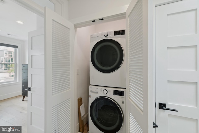 laundry room featuring stacked washer and dryer