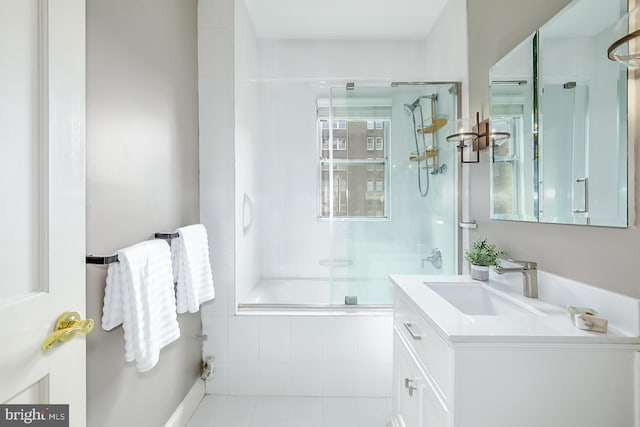 bathroom featuring tile patterned floors, bath / shower combo with glass door, and vanity