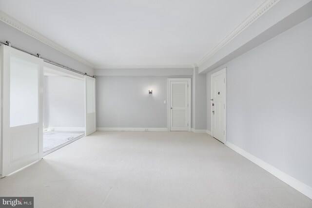 carpeted empty room featuring crown molding