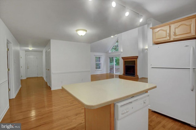 kitchen with rail lighting, white appliances, light brown cabinets, light hardwood / wood-style flooring, and a kitchen island