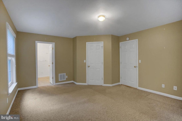 empty room featuring light colored carpet