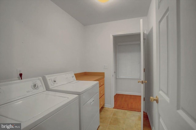 laundry room featuring cabinets and separate washer and dryer