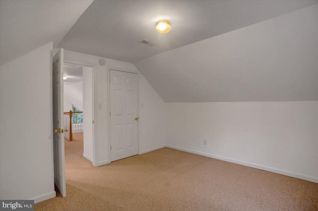 bonus room featuring light colored carpet and lofted ceiling