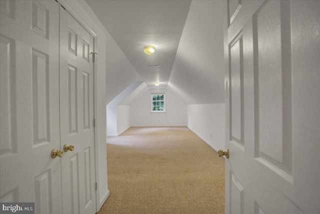 bonus room featuring light carpet and lofted ceiling