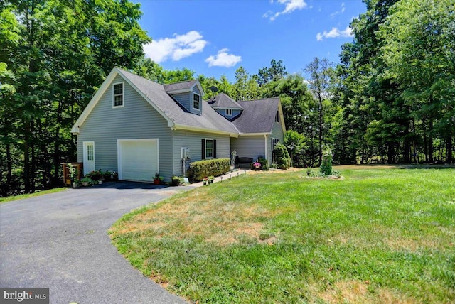 cape cod-style house featuring a garage and a front lawn