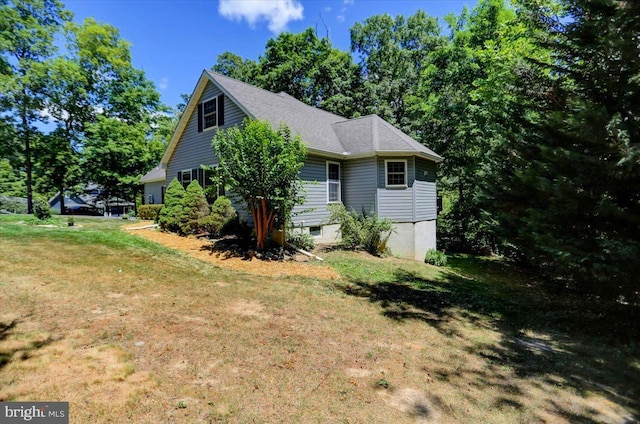 view of side of property with a yard