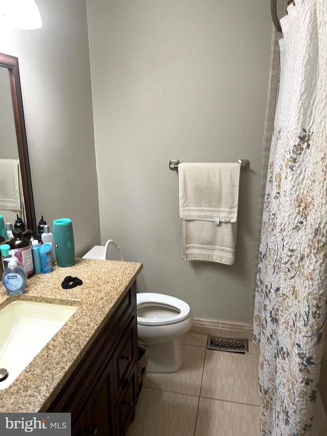 bathroom featuring tile patterned floors, vanity, and toilet