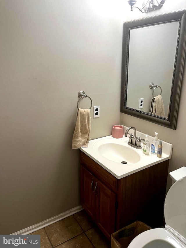 bathroom featuring tile patterned floors, vanity, and toilet