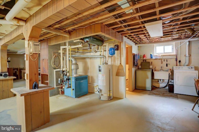 basement with washing machine and clothes dryer, water heater, and sink