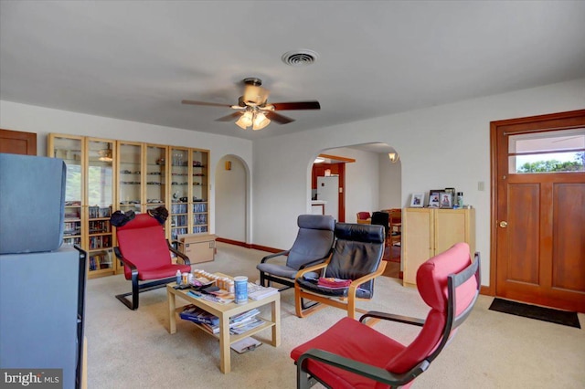 living room with ceiling fan and light carpet