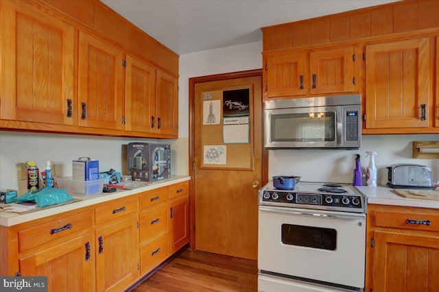 kitchen featuring light hardwood / wood-style floors and white electric range