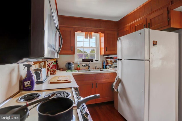 kitchen featuring white refrigerator, electric stove, dark hardwood / wood-style floors, and sink