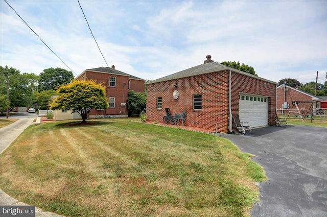 view of side of home featuring a lawn and a garage