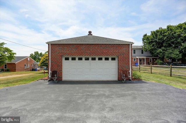 view of side of home featuring a garage and a yard